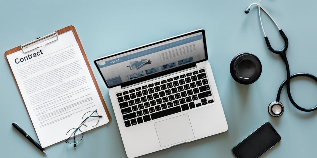 laptop on a medical desk with stethoscope