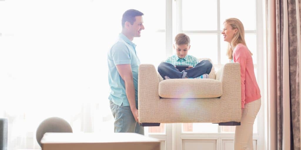 young couple carrying child on cheap quality furniture they just bought