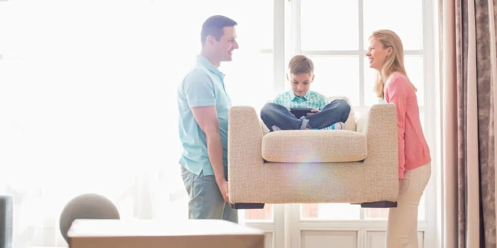 young couple carrying child on cheap quality furniture they just bought