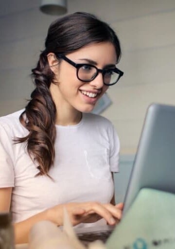 young girl on laptop with glasses