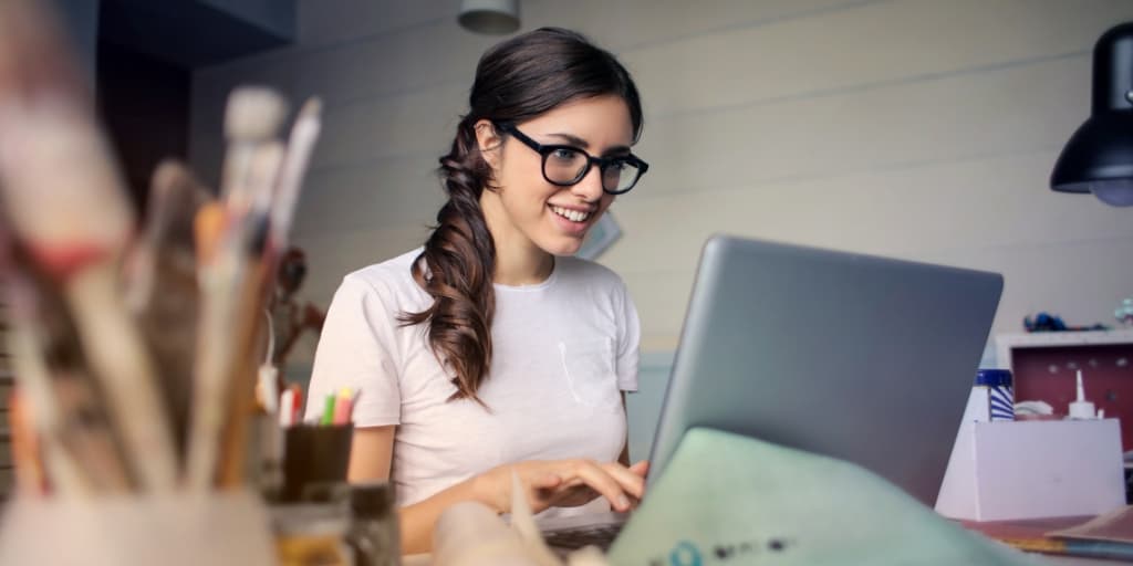 young girl on laptop with glasses