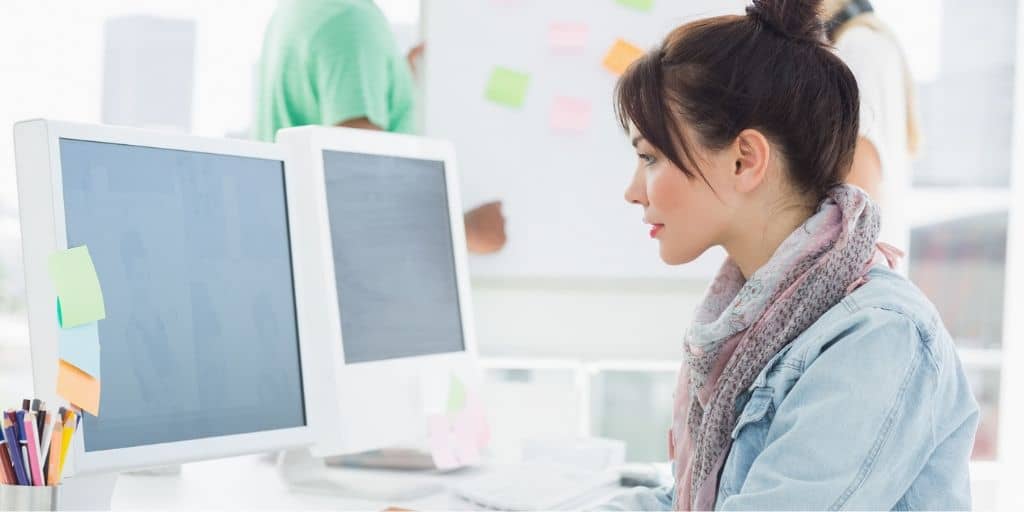 young professional woman at her cubicle office