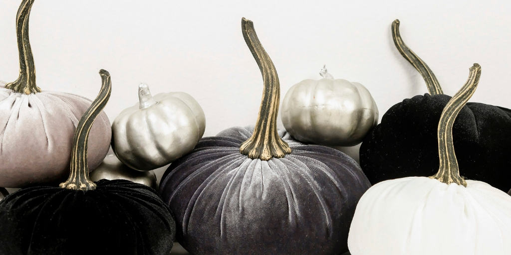 black, charcoal gray, and white pumpkins on a white background