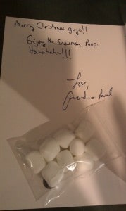 Picture of Christmas card with message to enjoy Snowmen poop, and a small bag of small marshmallows