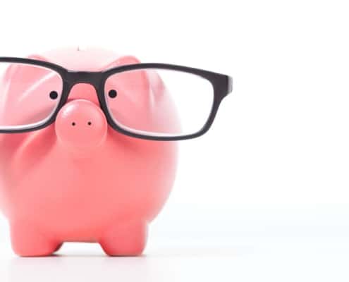 pink piggy bank with black glasses, on white background