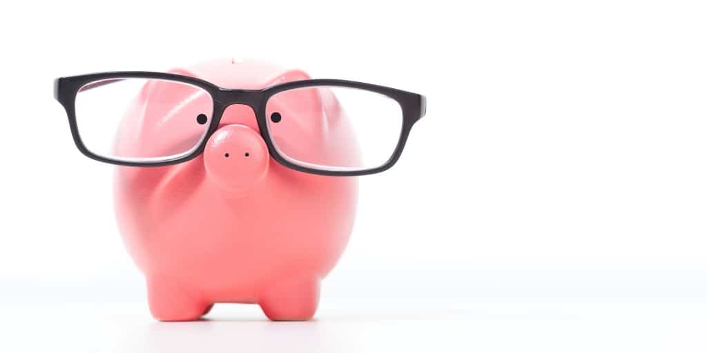pink piggy bank with black glasses, on white background