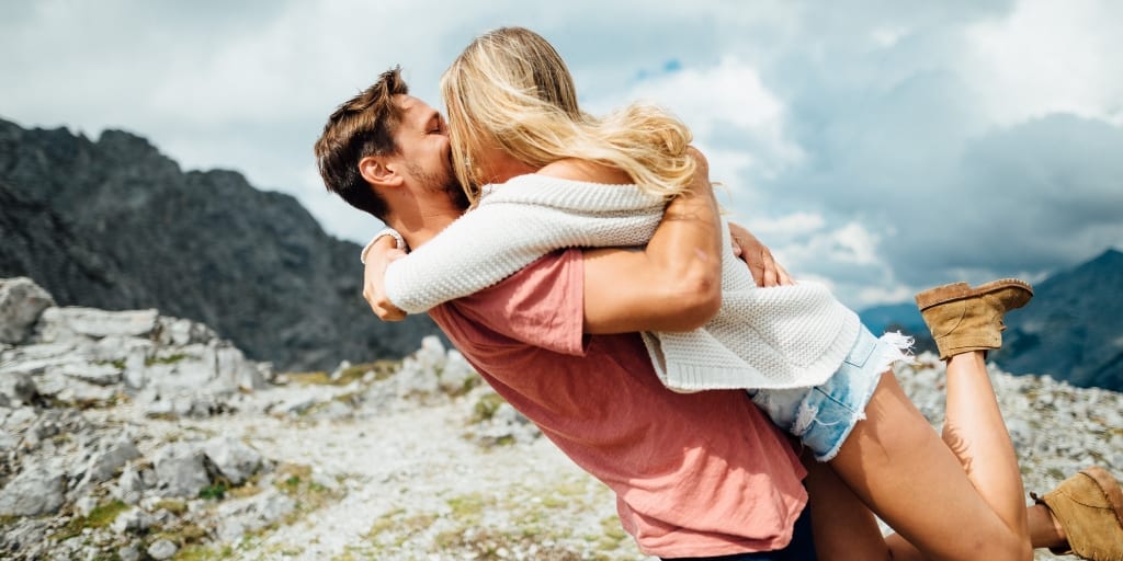 young couple excitedly embracing because they paid off their mortgage faster