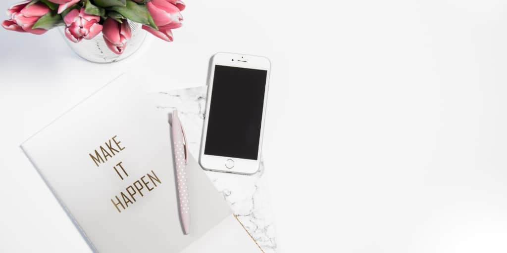 white desk with notepad that says 