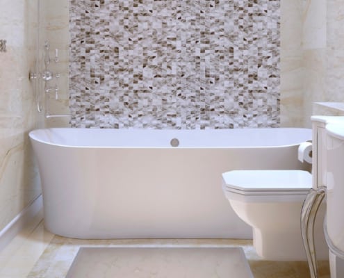bath tub and european toilet with a mosaic tile background