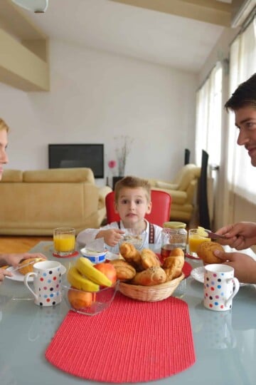 young couple having at home date night with child in between