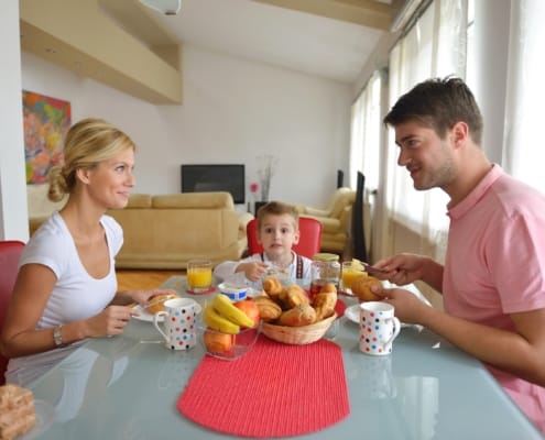 young couple having at home date night with child in between