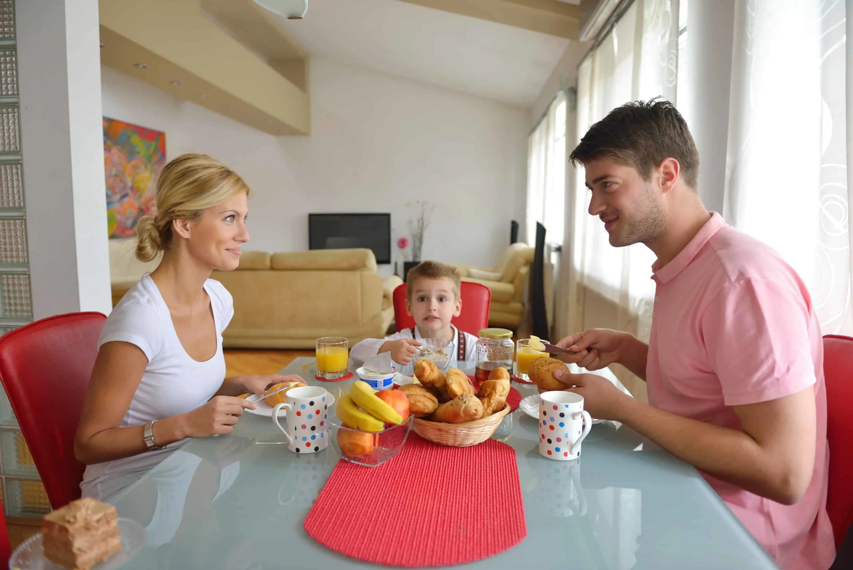 young couple having at home date night with child in between