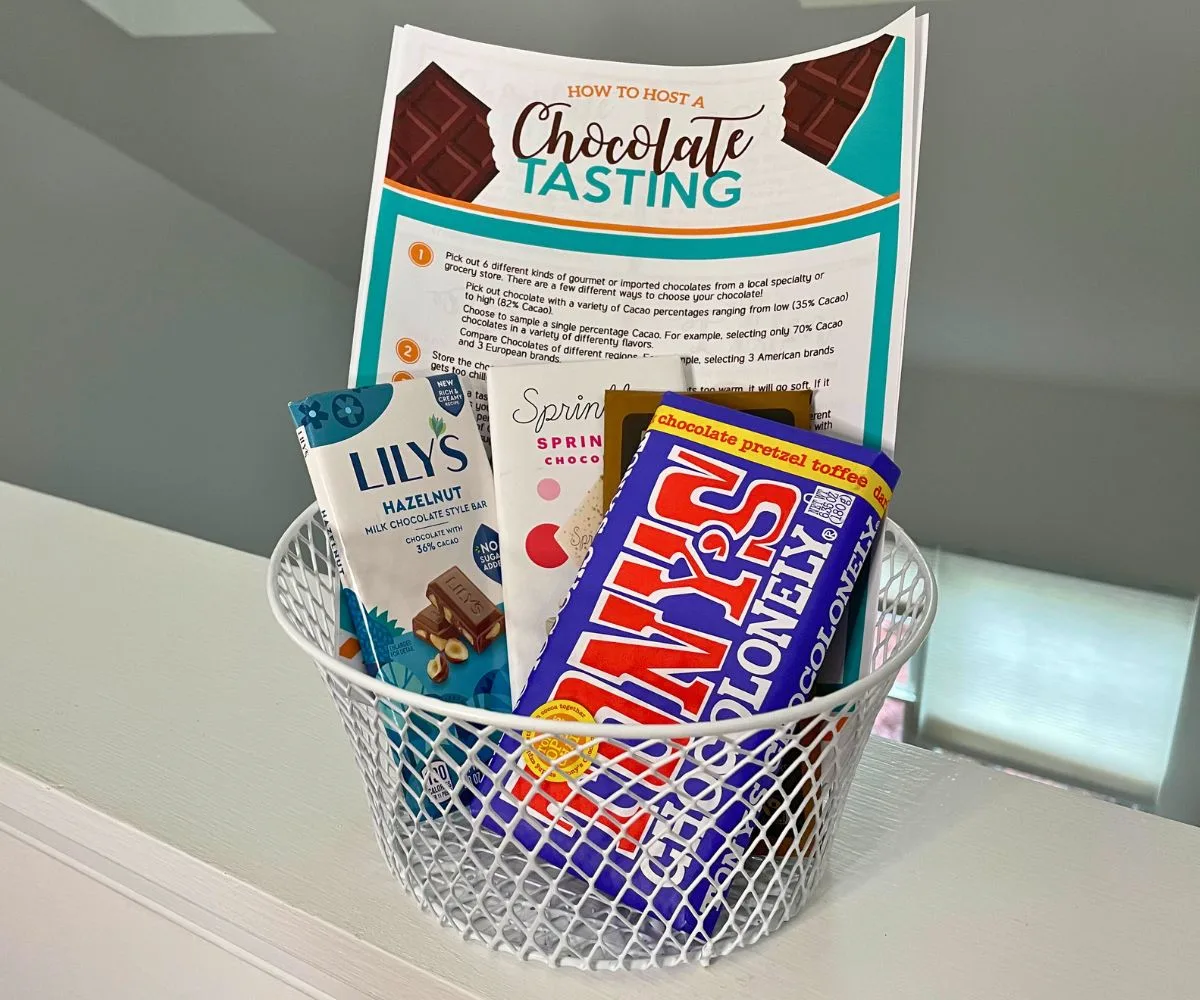 white wire basket filled with chocolate bars and free printable Chocolate Tasting