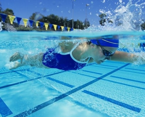 woman swimmer athlete in pool, looking for companies wanting to sponsor athletes