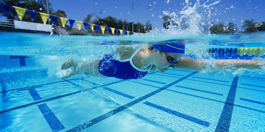 woman swimmer athlete in pool, looking for companies wanting to sponsor athletes