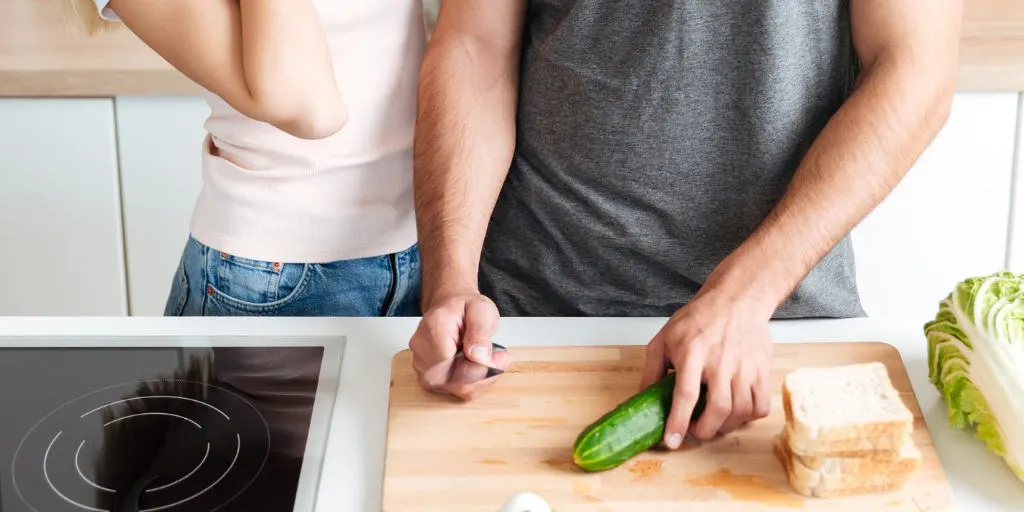 a couple in the kitchen, flirting and cooking