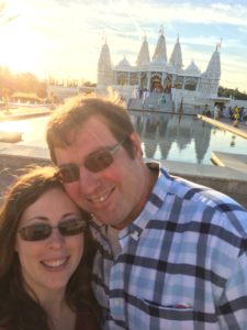 picture of author and husband smiling together in front of Indian temple
