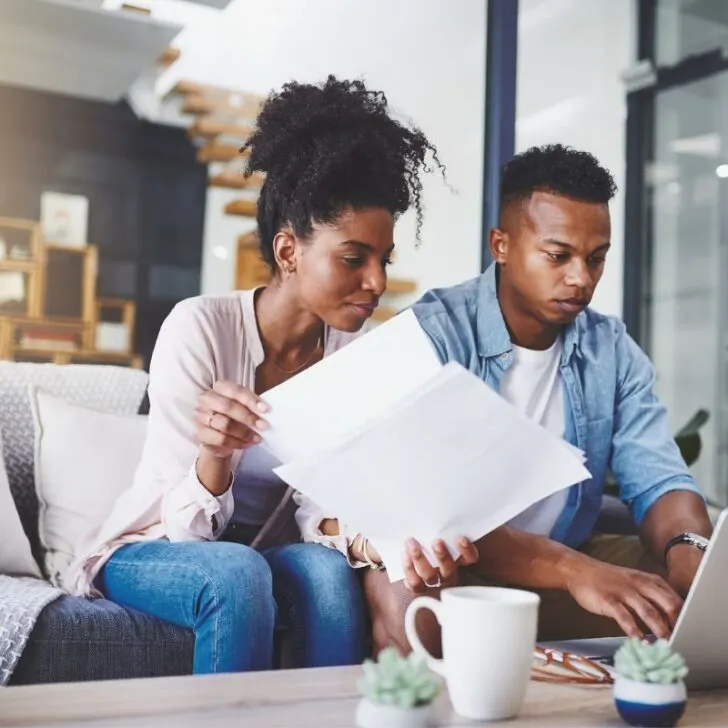 couple looking over tax appraisal paperwork at home and creating argument