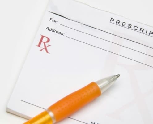 prescription pad with pen, on white background