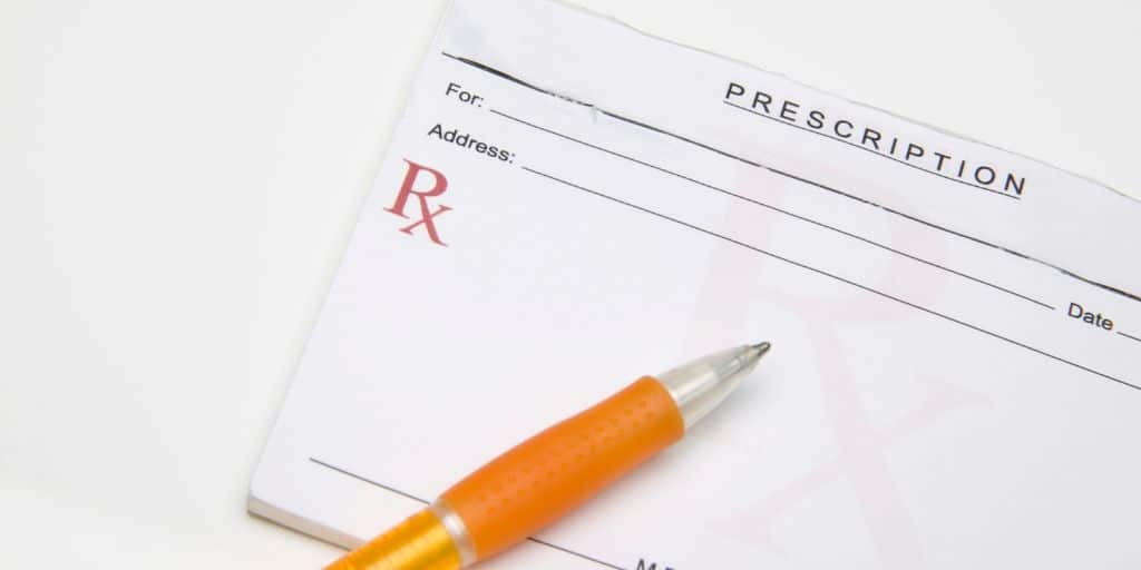 prescription pad with pen, on white background