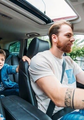 two parent and one child family in car, who downsized to one car family