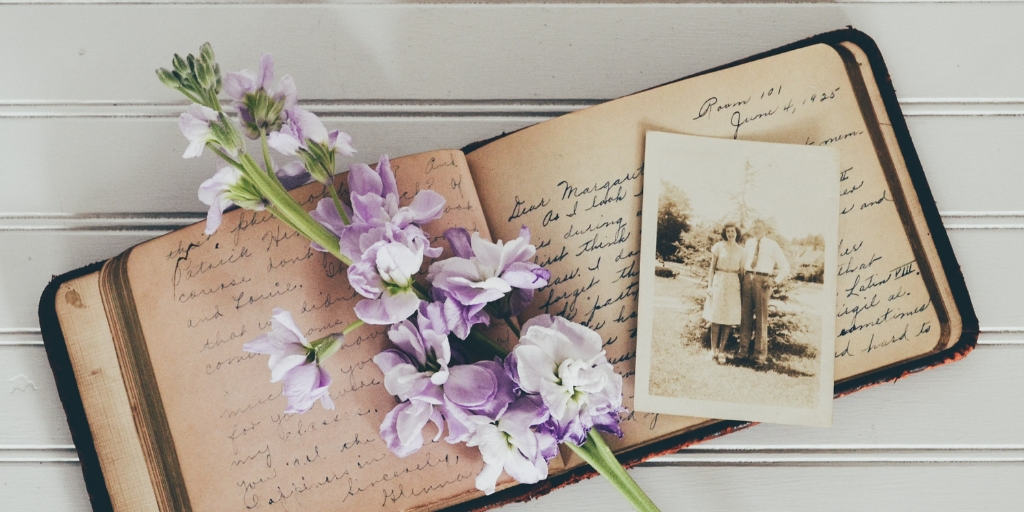 Genealogy Project book with purple flowers on top