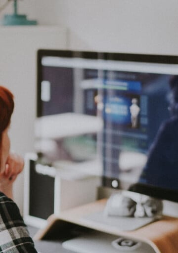 woman in front of computer, anxious, looking for employment