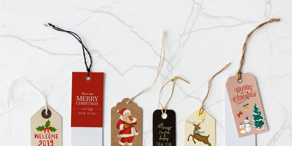 holiday gift tags on a marble desktop background