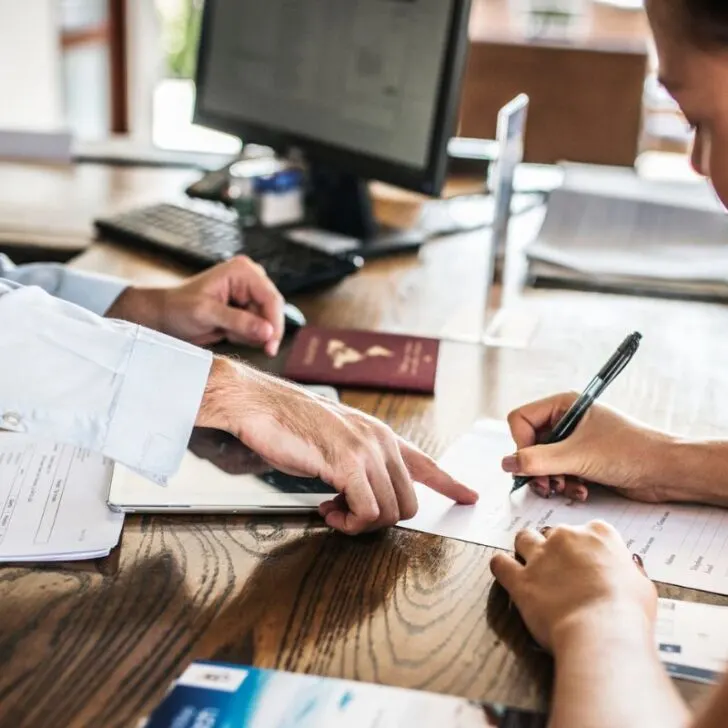 aggressive sales man showing where to sign after timeshare presentation