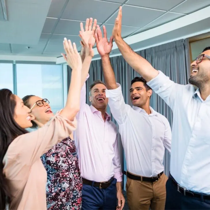 group of coworkers giving high fives