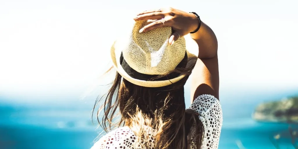 woman looking out over ocean, thinking of staycation ideas