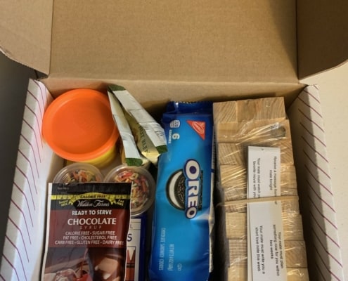 picture of datelivery box with oreos, play doh, wooden blocks, and more