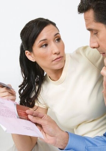 wife and husband dealing with zombie debt collector on phone