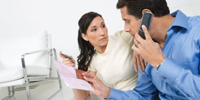 wife and husband dealing with zombie debt collector on phone