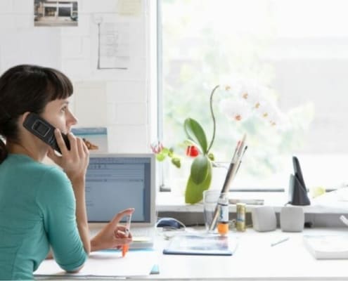 young woman on phone, negotiating after getting her credit sesame score