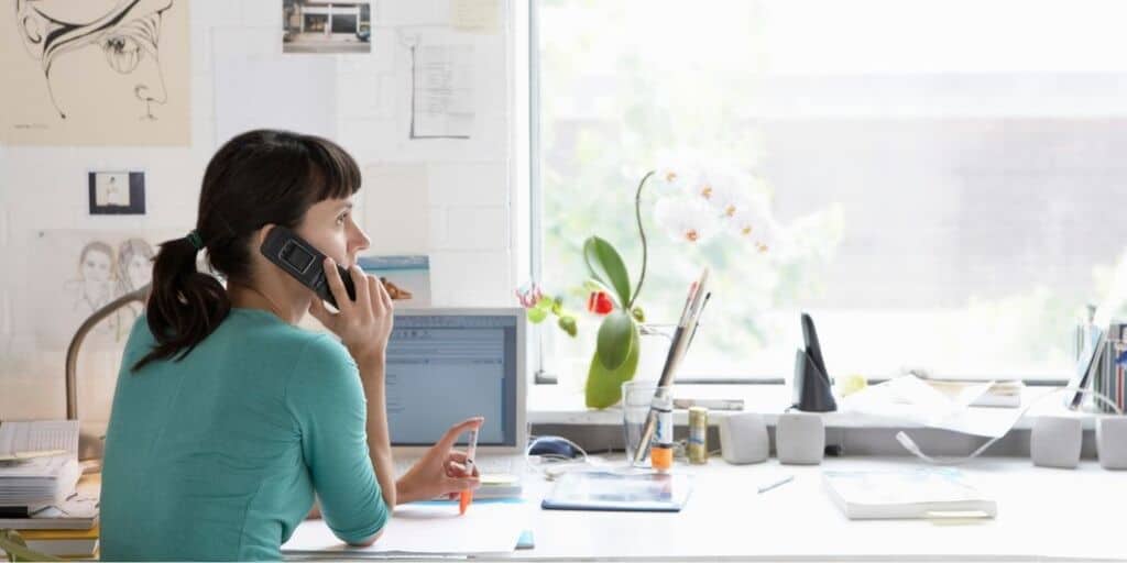 young woman on phone, negotiating after getting her credit sesame score