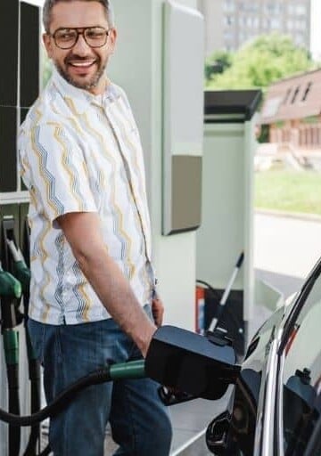woman and man getting gas at start of things to do in the car for adults