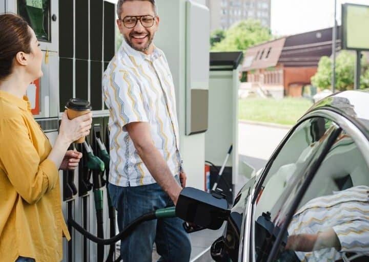 woman and man getting gas at start of things to do in the car for adults