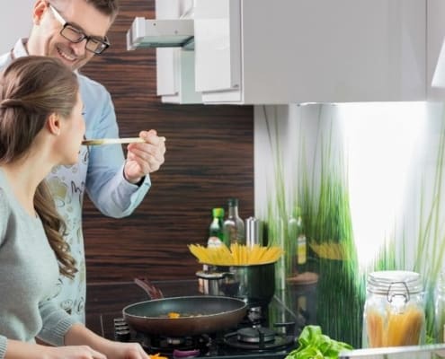 couple cooking together, working on correcting money imbalance in relationship