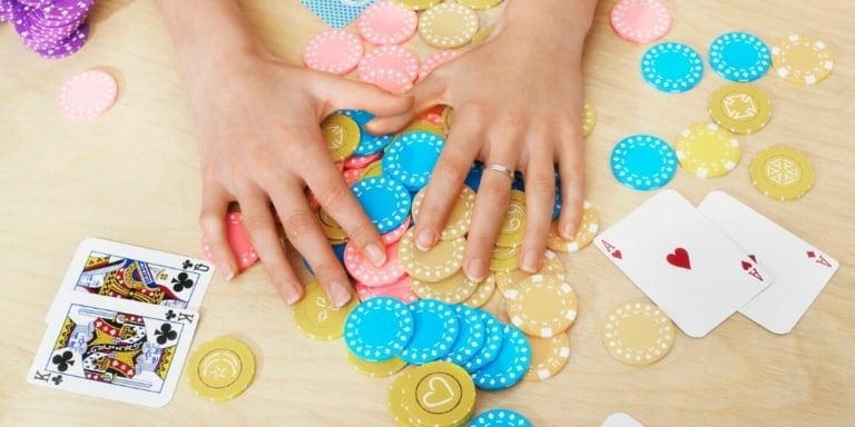 table flatlay with poker chips and cards, fun money saving games