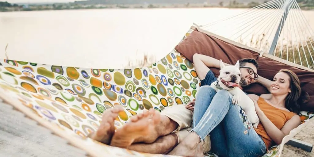 couple laying on hammock, exciting about how to pay off 40k fast