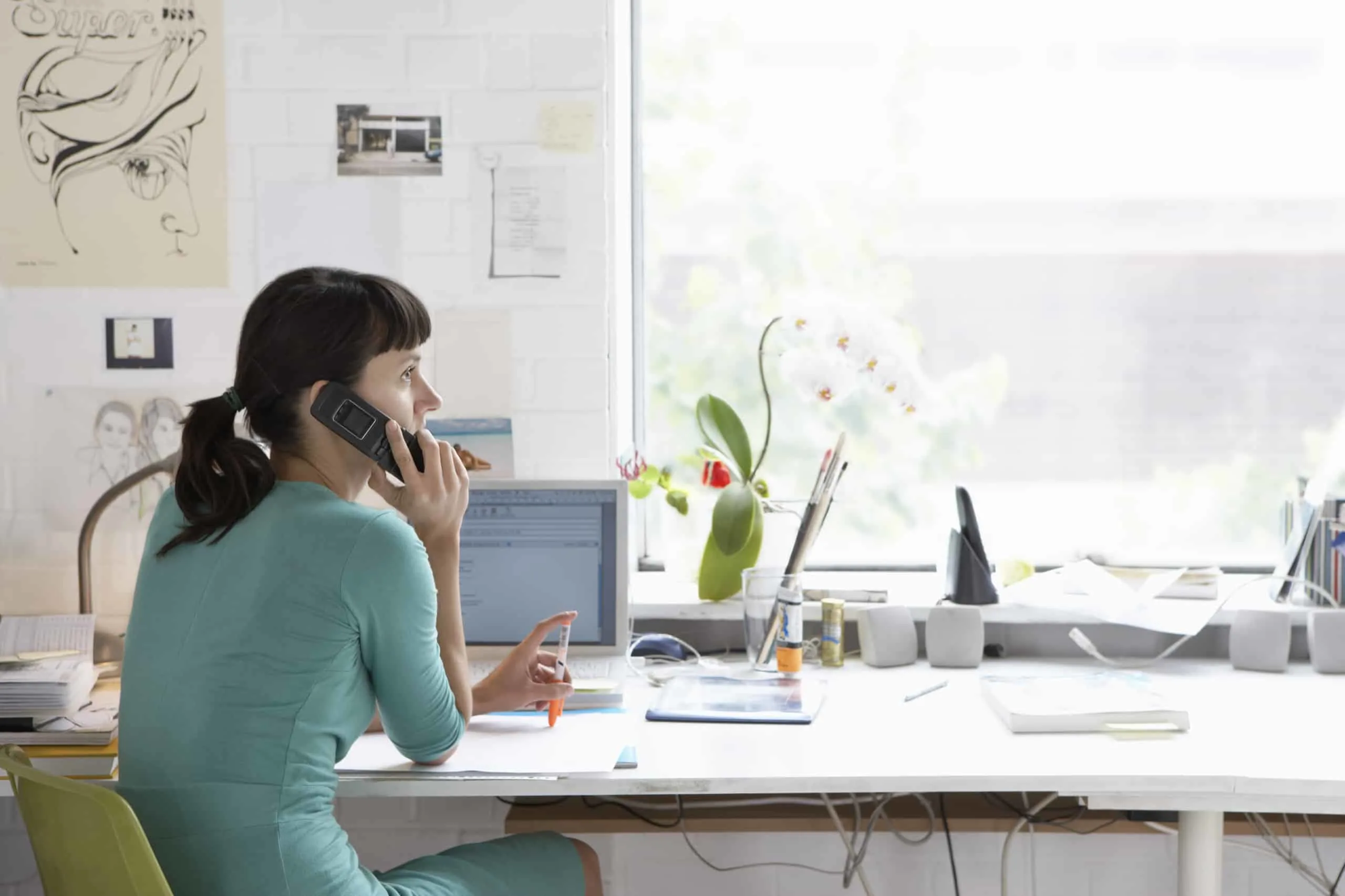 young renter on phone in apartment, negotiating rent with a property management company