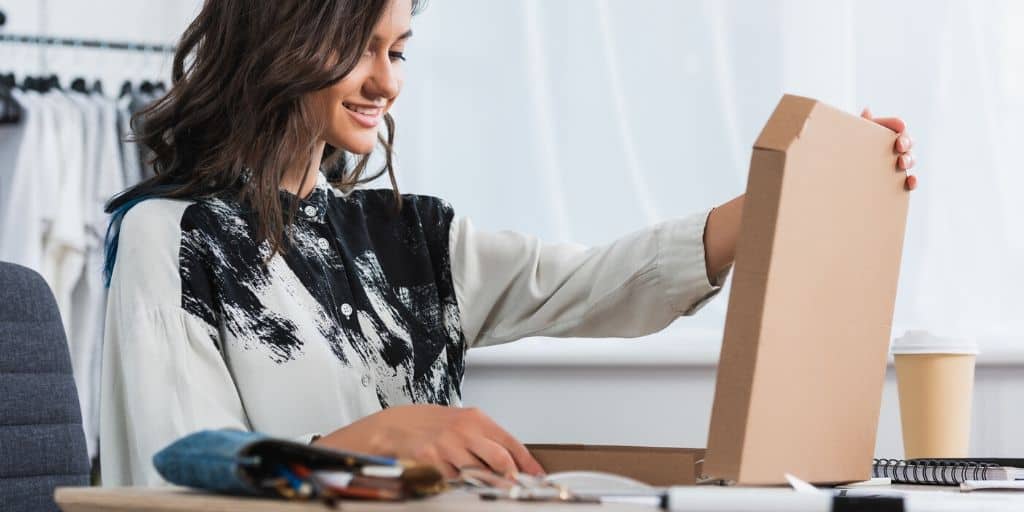 woman opening up free sample box by mail she received with no shipping no catch