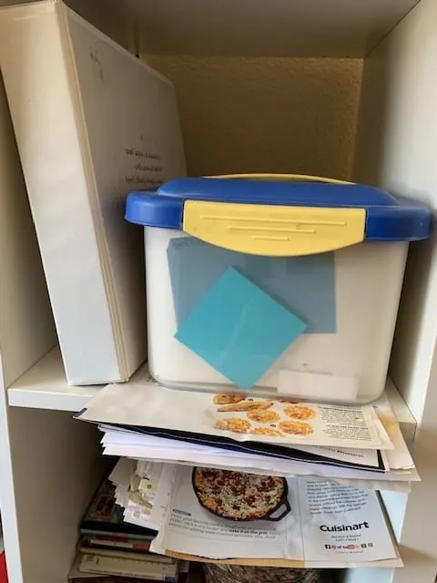 image of old recipe binder system with recipe caddy holding recipe cards, and piles of recipes from magazines