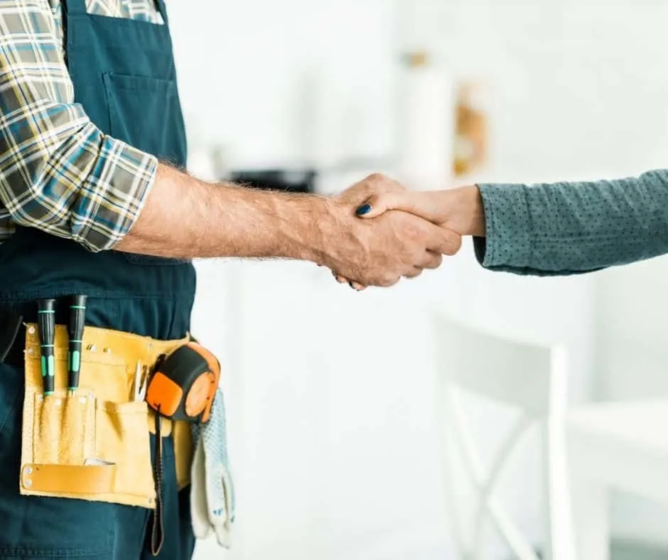 woman shaking hands with contractor - how to negotiate with contractors