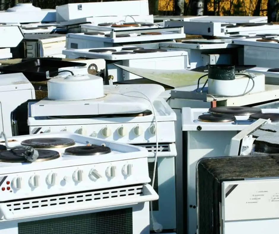 bunch of broken appliances at a junk yard about to be scrapped - who buys broken appliances