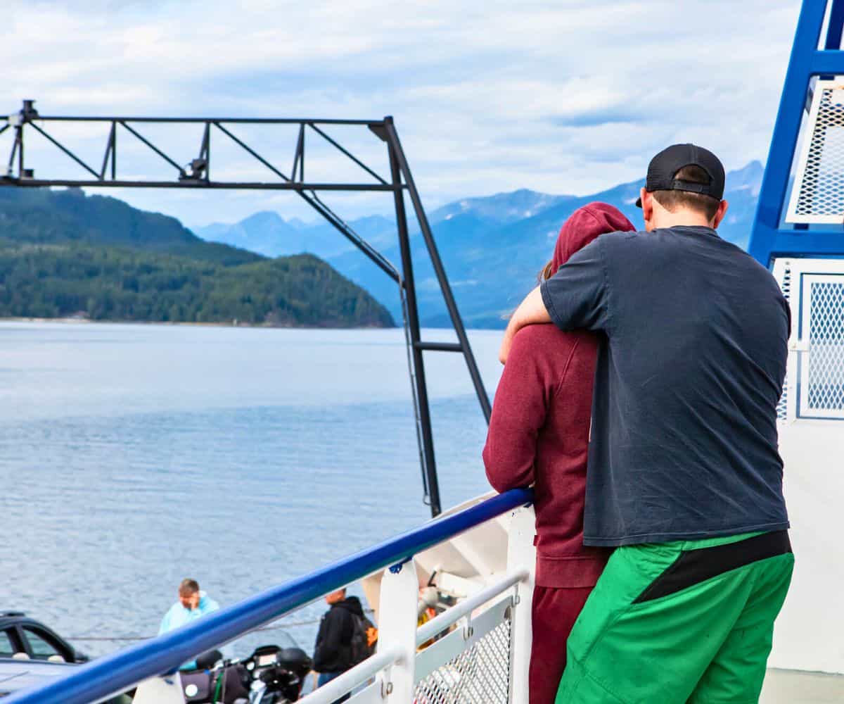couple hugging on a ferry ride across water