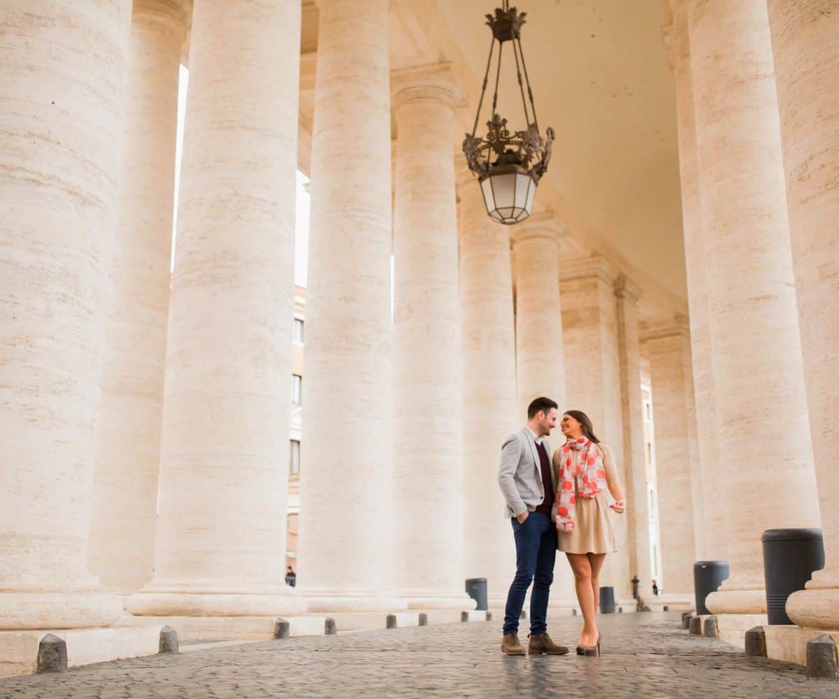 couple dressed nicely with large columns around them outside of state capitol building