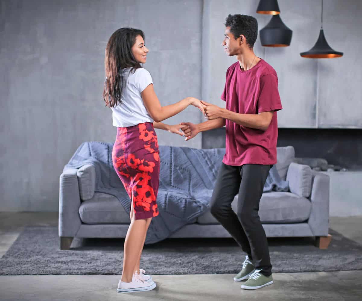 Same couple, doing a different dance move in living room