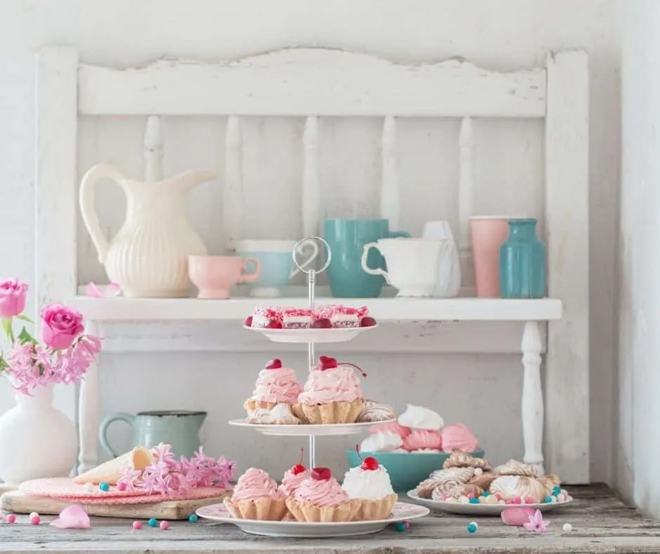 three tier cake and tea cake platter filled with gorgeous pastries on white background